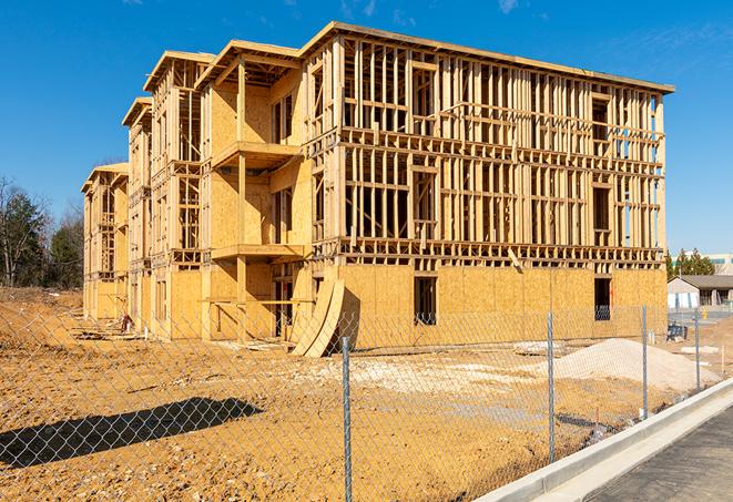 a temporary chain link fence in front of a building under construction, ensuring public safety in El Lago TX